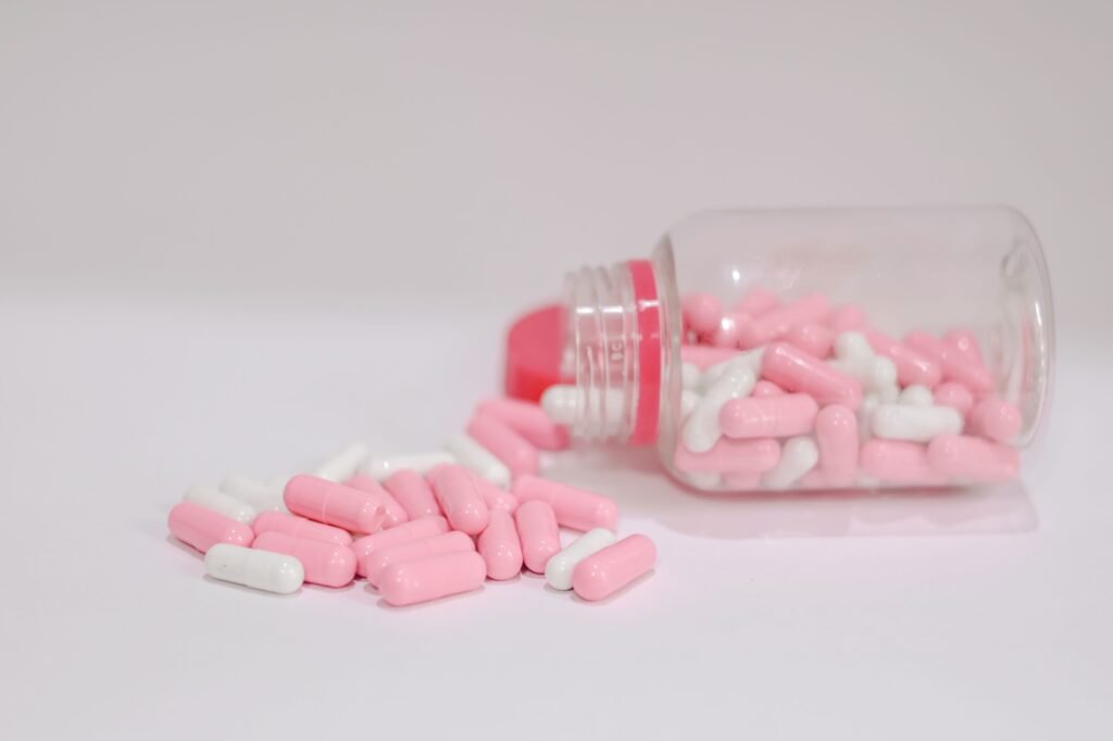 Antibiotic capsules spilled from a bottle