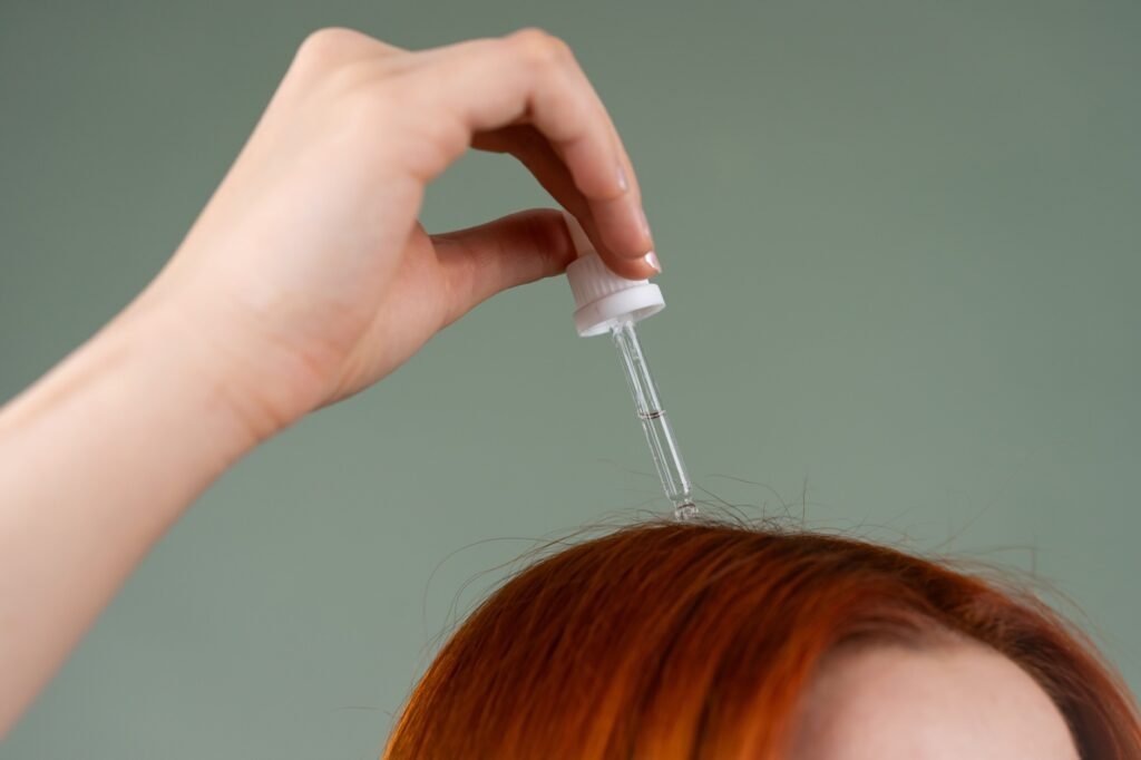 Applying a medicated scalp treatment directly to the roots