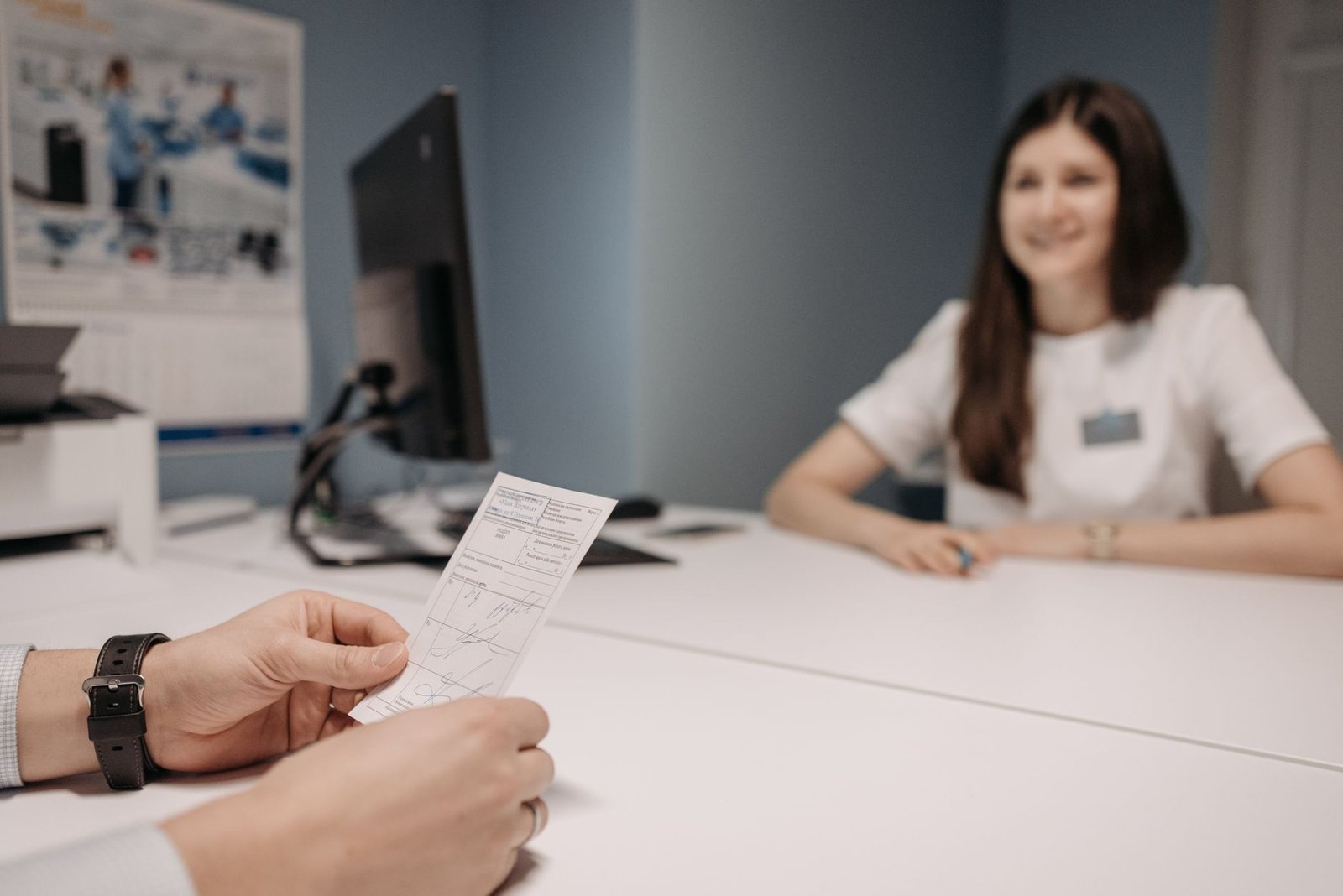 Doctor discussing a prescription with a patient in a clinic office