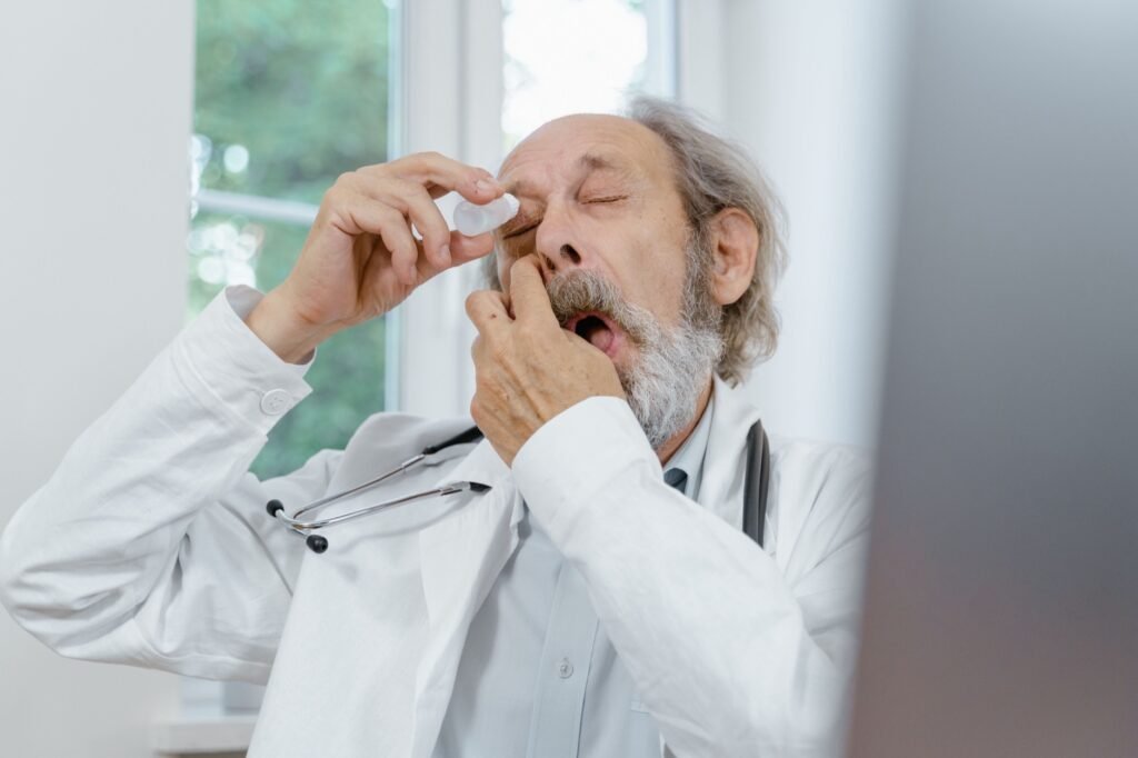 Elderly patient having hypertonic saline eye drops applied for corneal edema