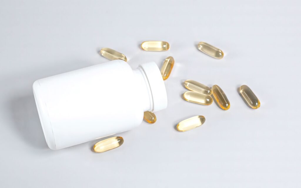 Fish oil softgel capsules spilled from a bottle