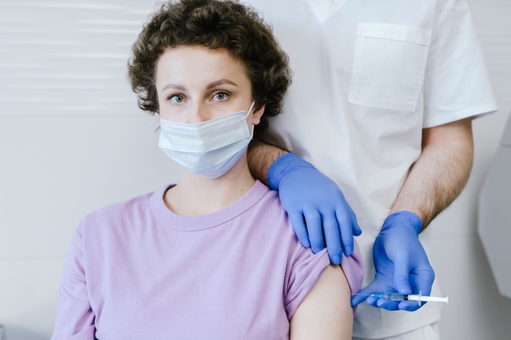 Healthcare worker administering a Tdap vaccine injection
