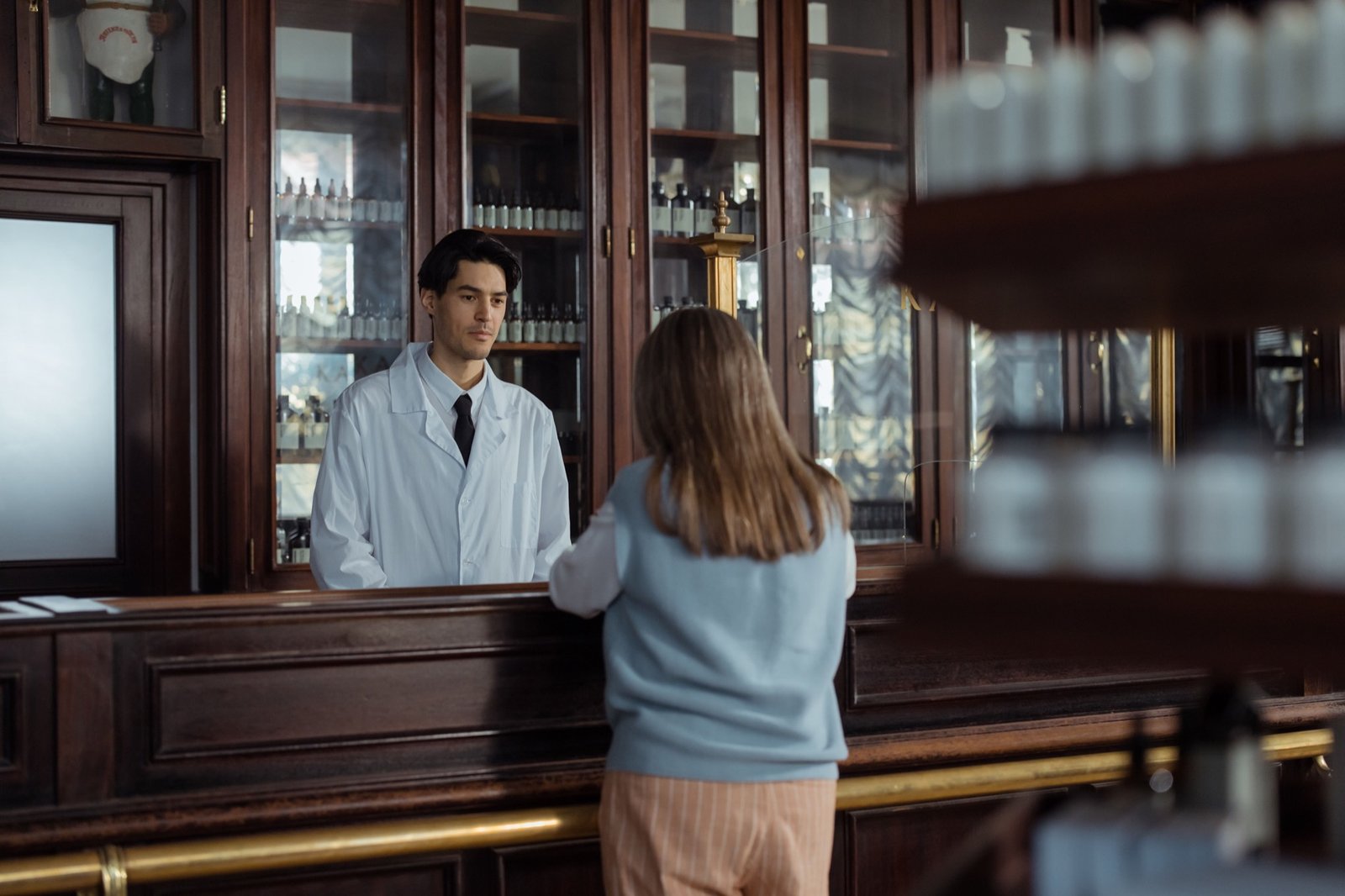 Pharmacist assisting a customer at the pharmacy counter