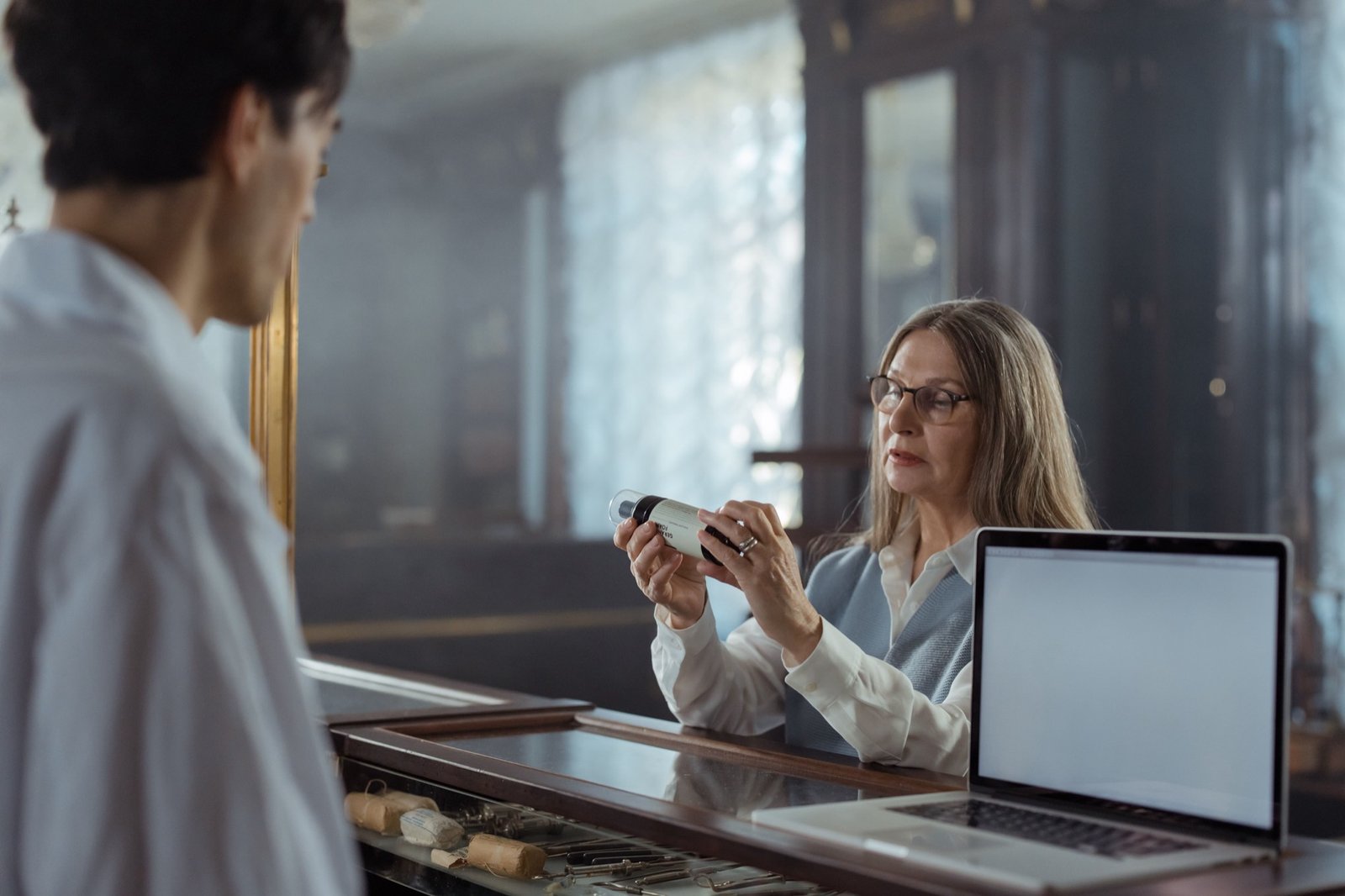 Pharmacist helping a customer with a medication question at the counter