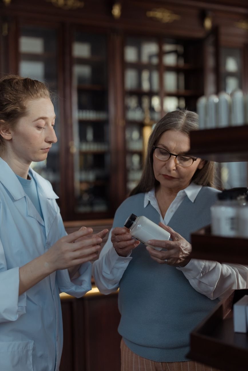Pharmacist helping a customer choose the right medication at the pharmacy counter