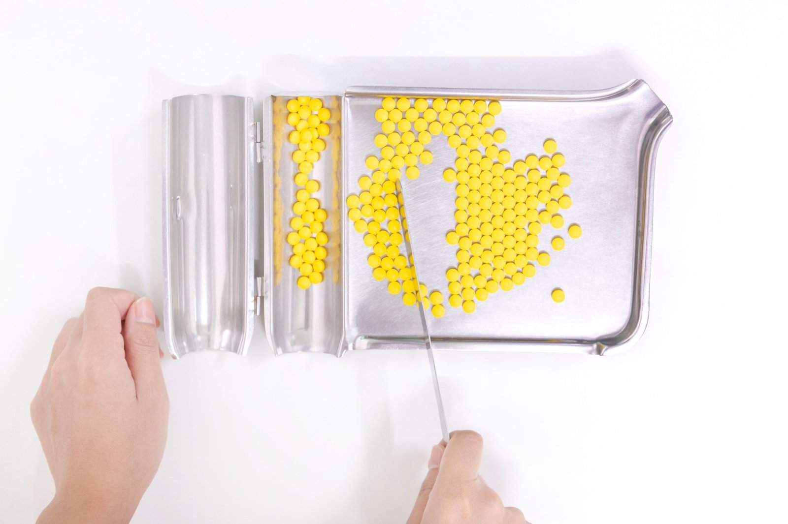 Pharmacy technician organizing pills on a tray