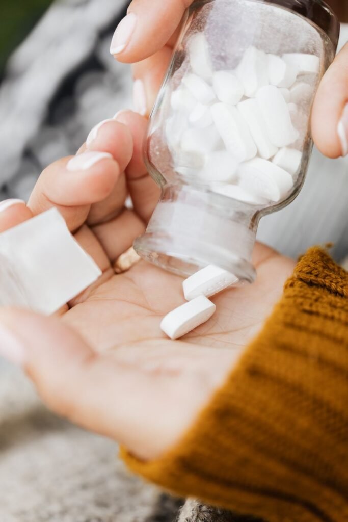 Chewable tablets being poured into a hand from a bottle