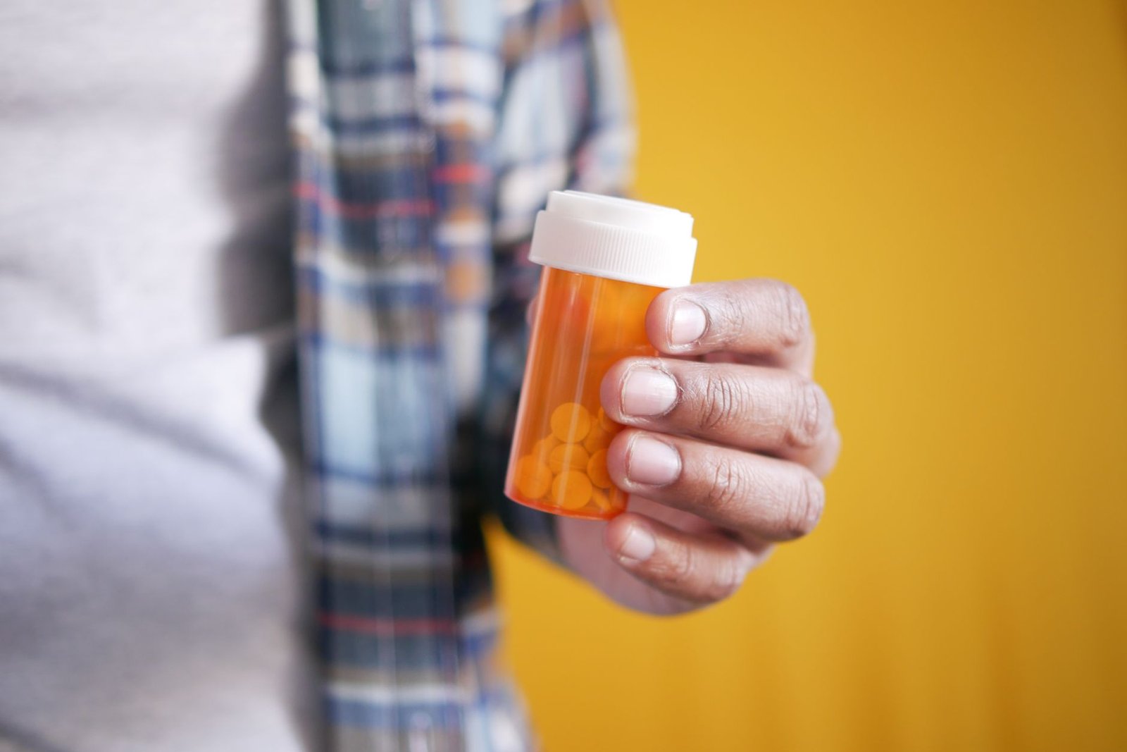 Hand holding a prescription medication bottle