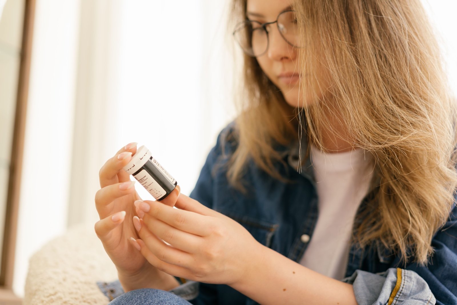 Woman carefully reading a medication label before use