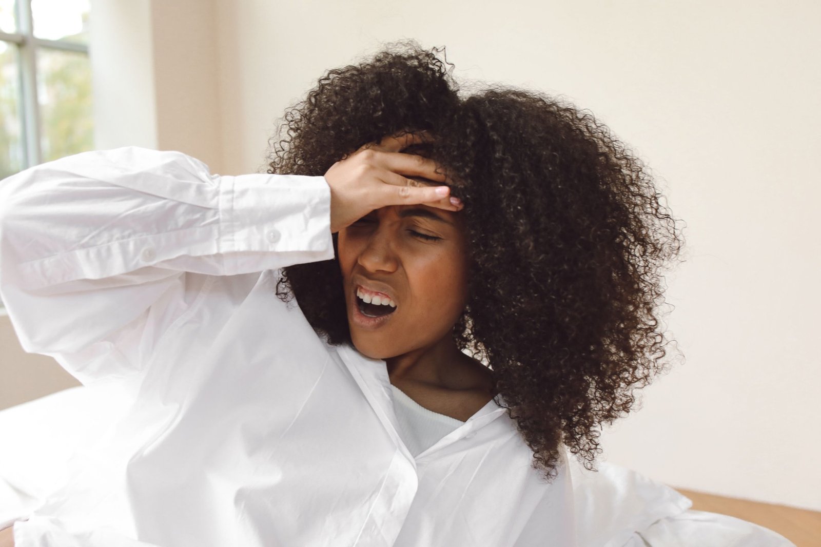 Woman waking up with a headache, a classic hangover symptom