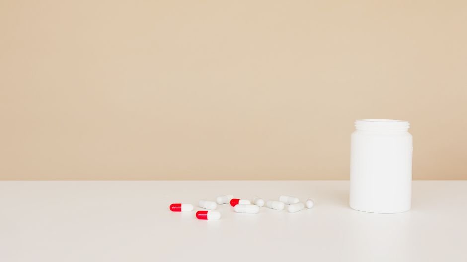 Bottle of probiotic capsules with pills