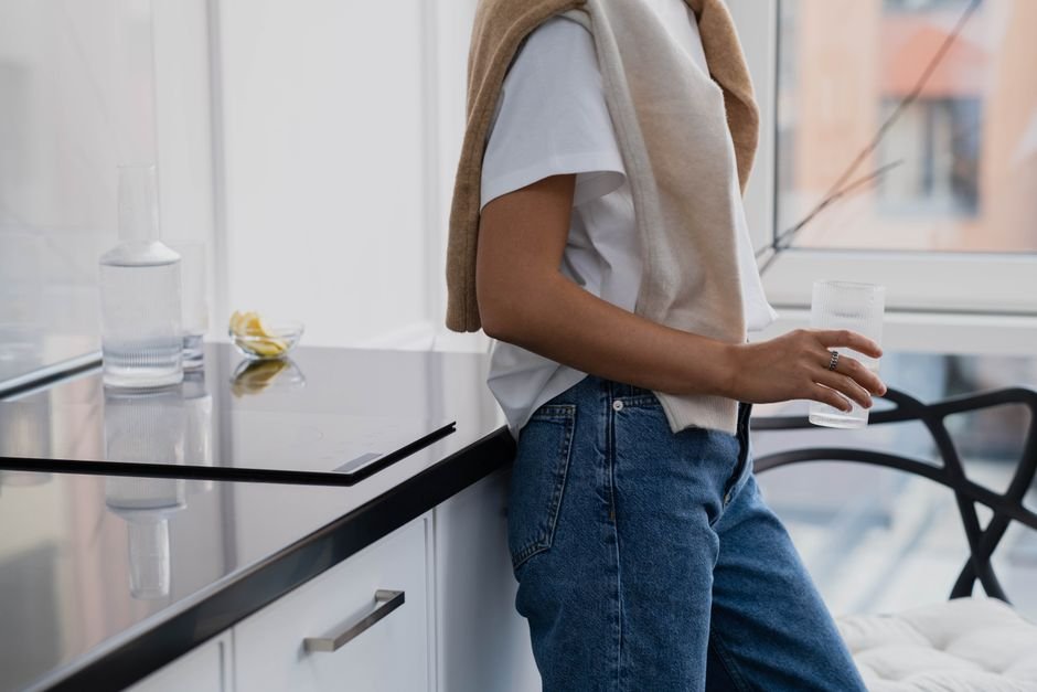 Glass of water being held in kitchen