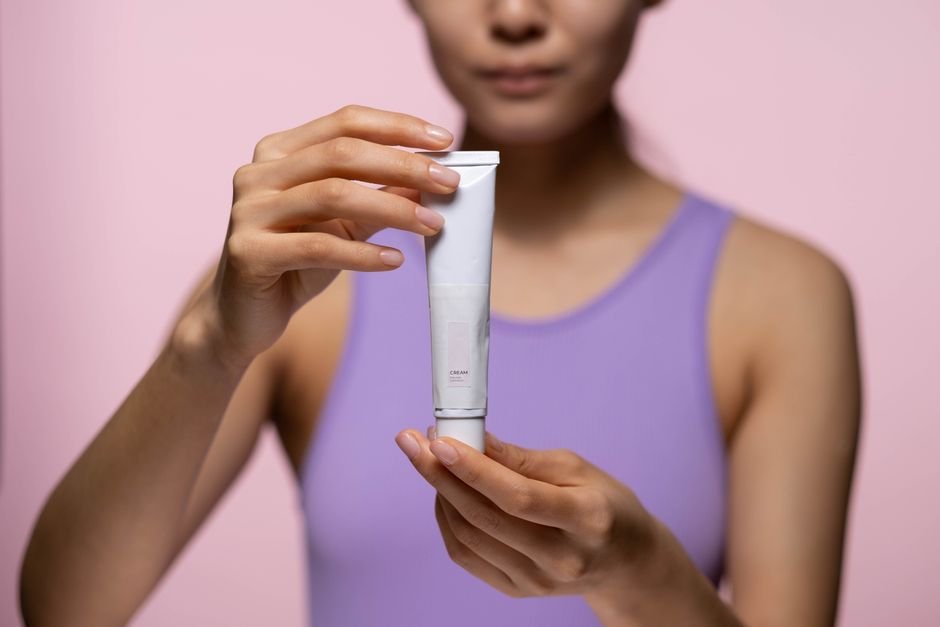 Hand holding a tube of anti-itch cream