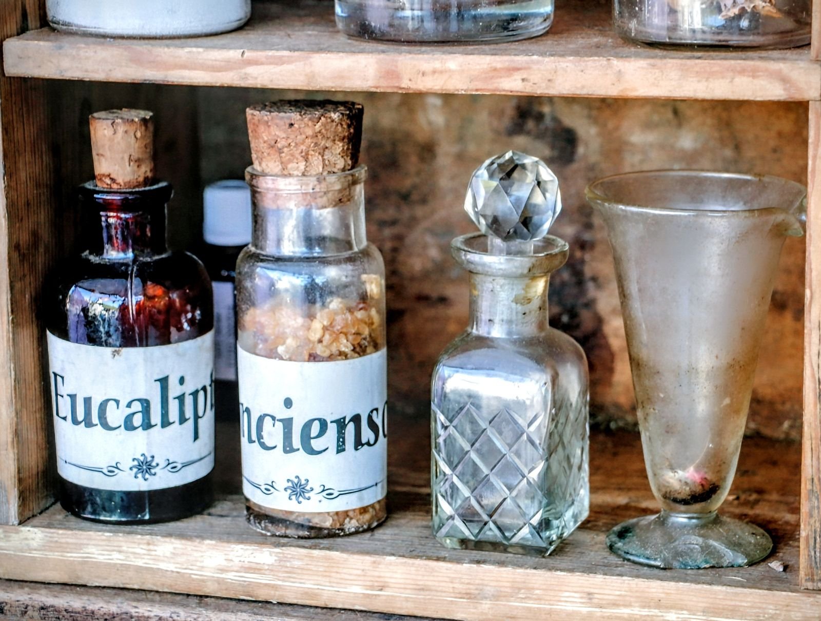 Vintage apothecary bottles on a wooden shelf, illustrating how the active ingredient decides how Preparation H works
