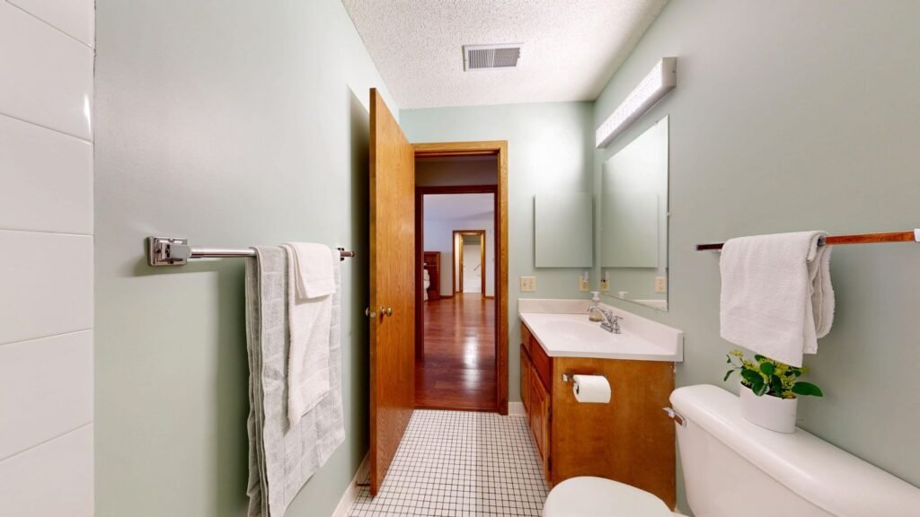Bright bathroom with a vanity, where a stool softener and hemorrhoid cream are often used together