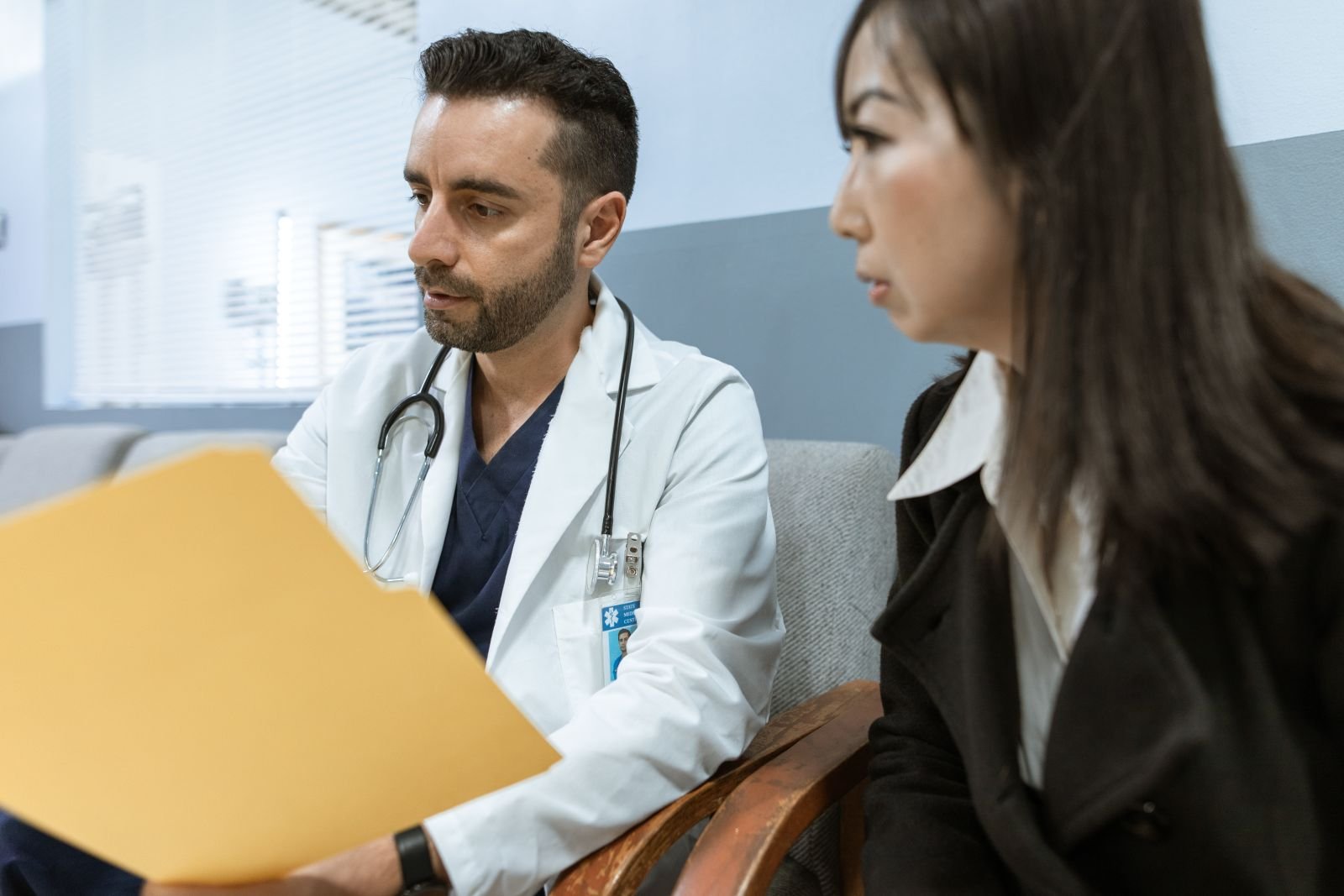 Doctor discussing health records with a patient about how long you can safely use hemorrhoid cream