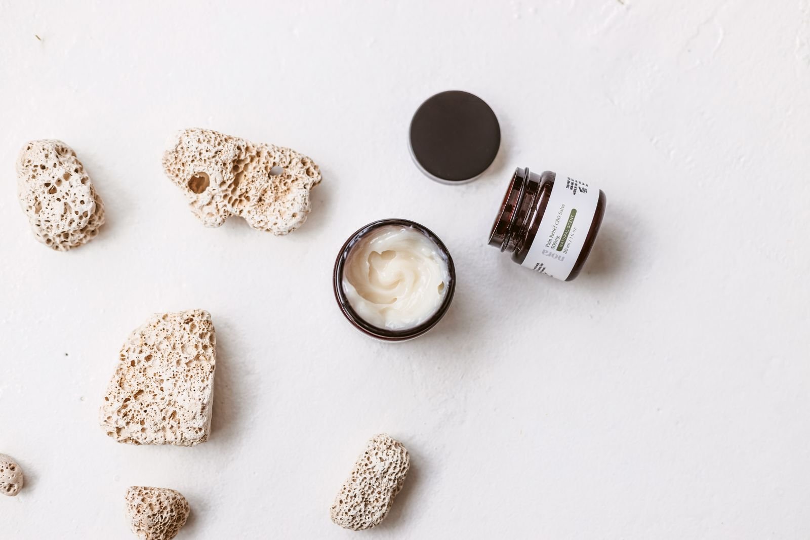 Top view of a skincare cream jar, representing the cream side of the hemorrhoid suppositories vs creams question