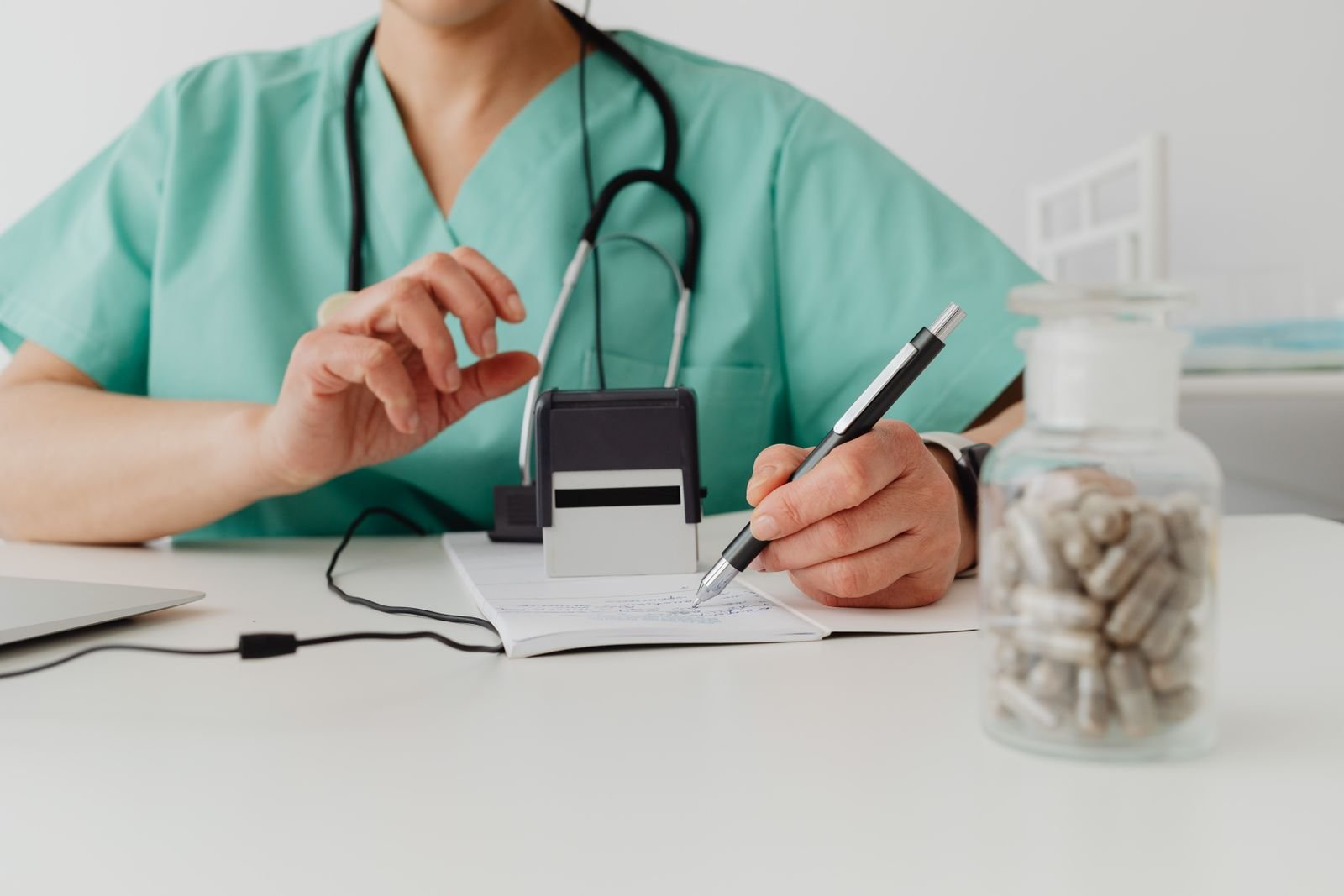 Doctor writing a prescription, since nitroglycerin ointment for fissures requires a doctor's prescription