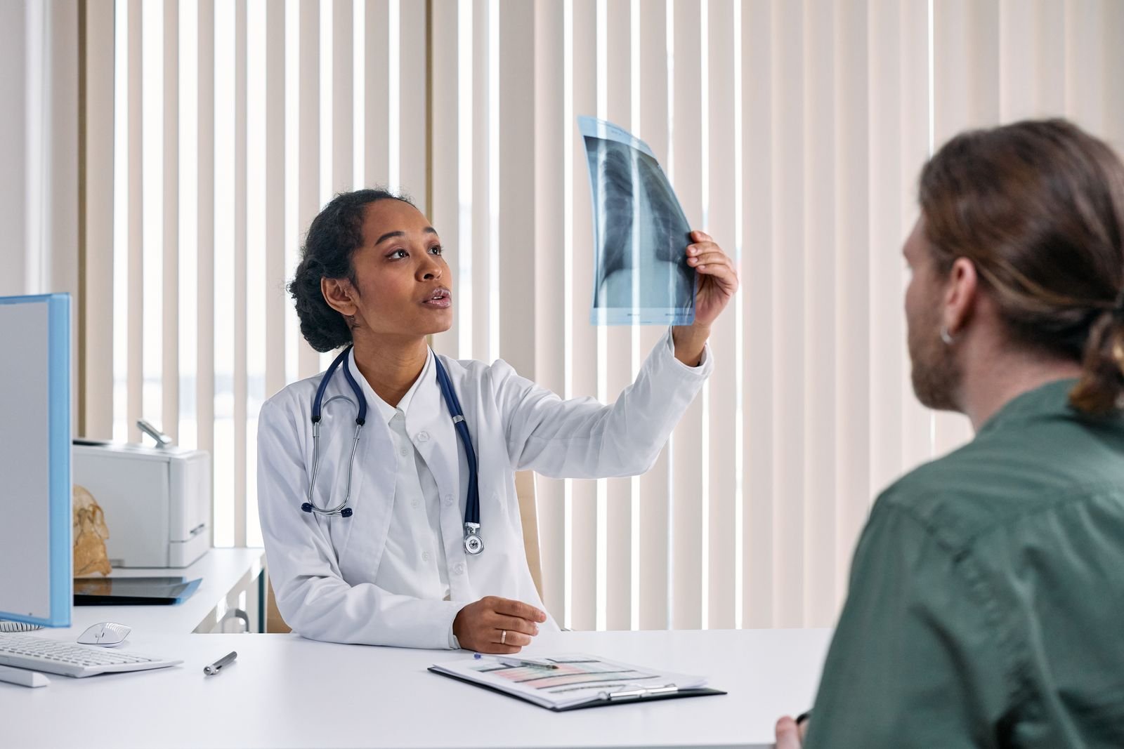 Doctor reviewing results with a patient to confirm whether it is hemorrhoids vs anal fissures