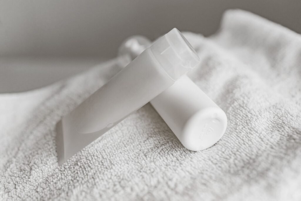 White cream tubes resting on a towel, representing the strongest numbing cream for hemorrhoids