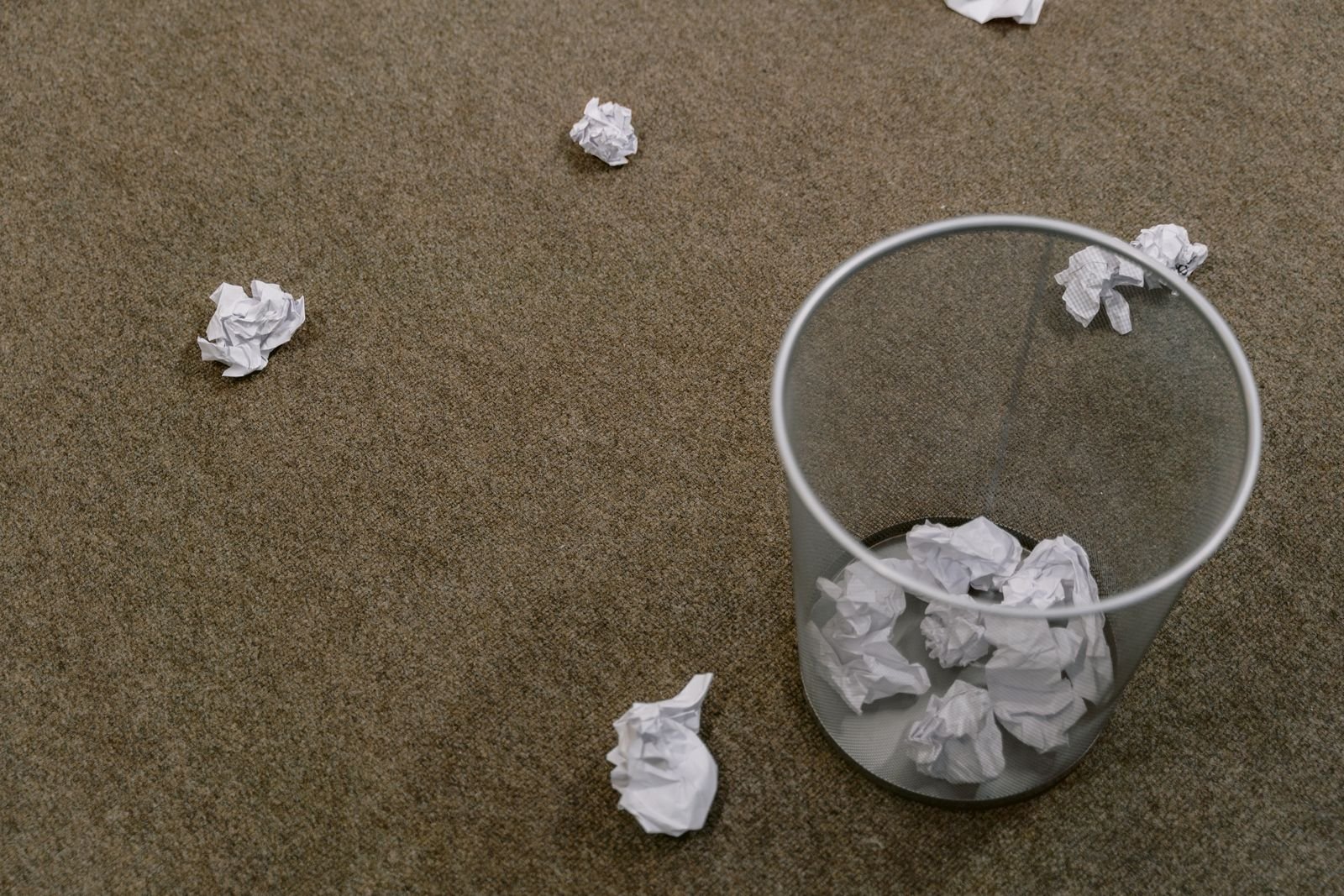Wastebasket on a carpeted floor, where used Tucks pads should go instead of the toilet