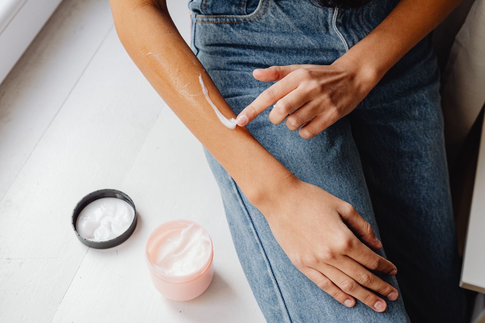 Person patch testing a cream on the inner forearm before using an herbal hemorrhoids cream