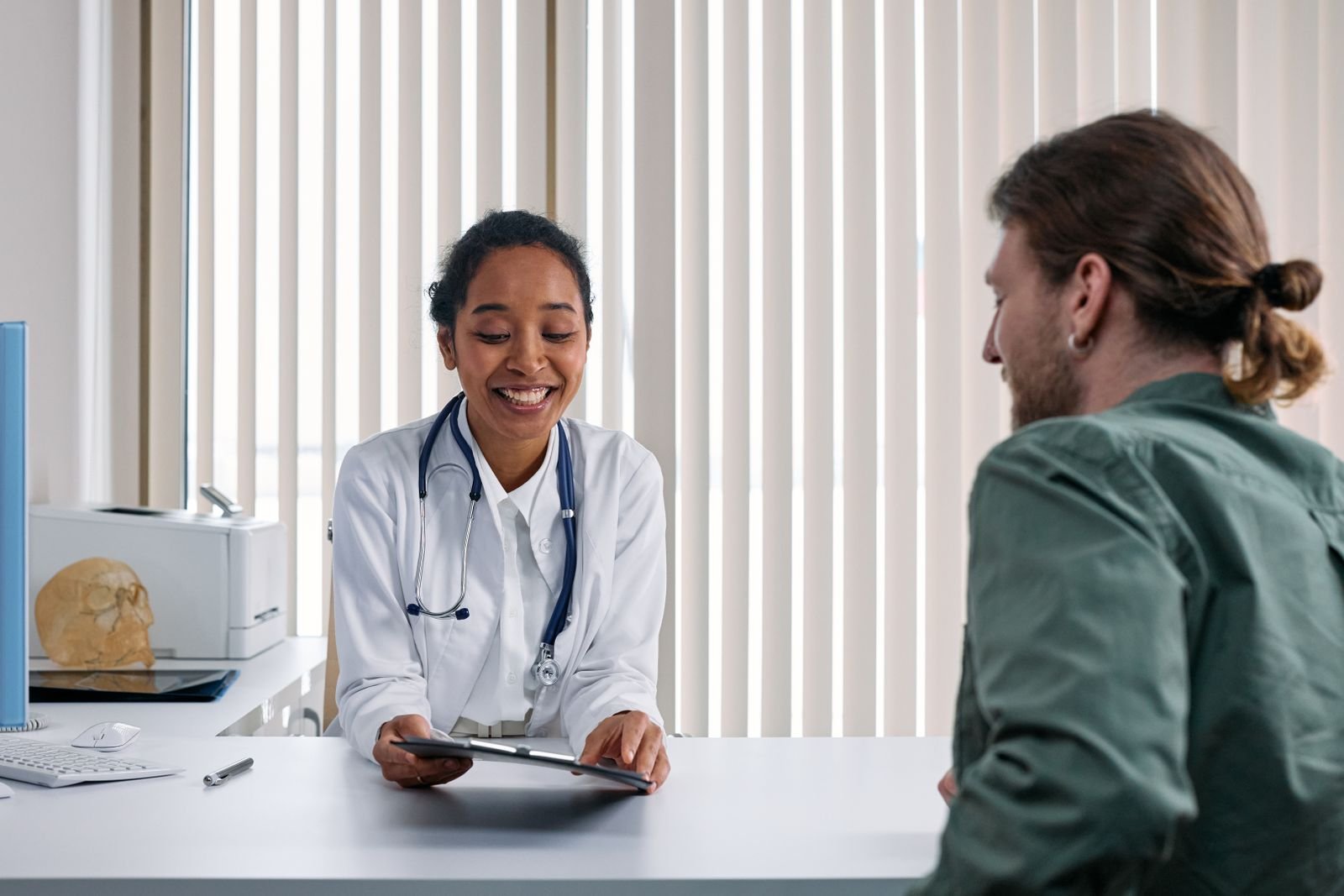 Doctor discussing options with a patient in a bright clinic, part of internal hemorrhoid treatment planning