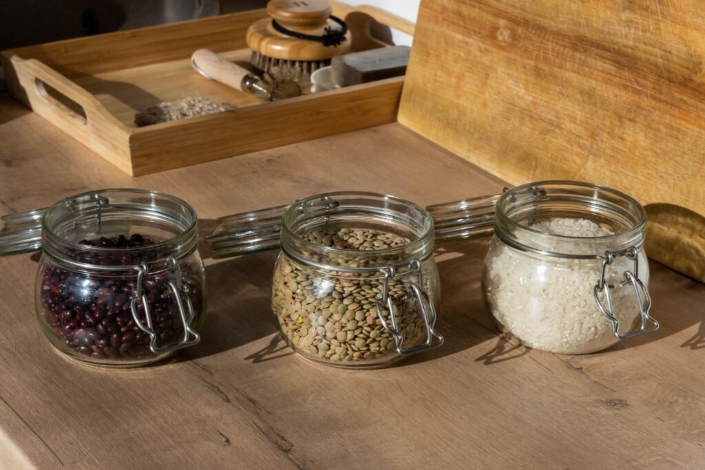 Glass jars of beans, lentils, and rice, fiber-rich foods that support hemorrhoid treatment for internal hemorrhoids